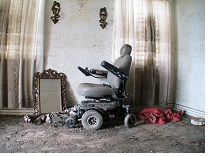 a motorized wheelchair in a room severely damaged by water and smoke