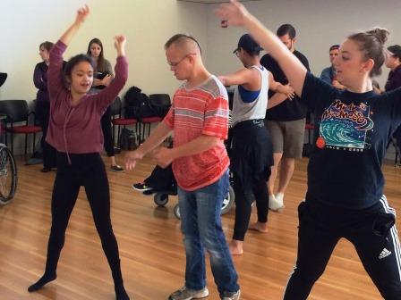 ten people dancing in a room with a hardwood floor