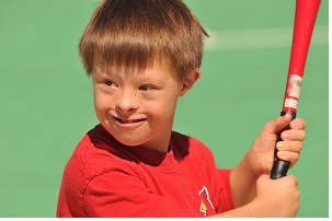 A child with Down syndrome playing baseball