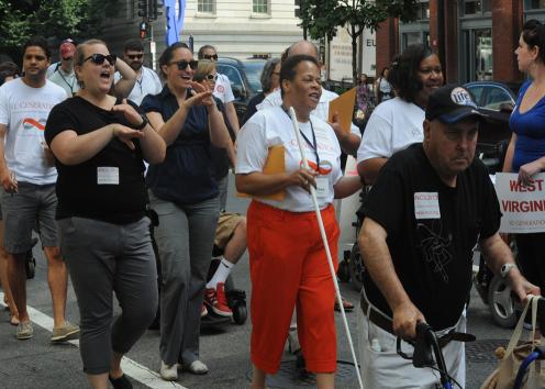 People with disabilities march through the streets